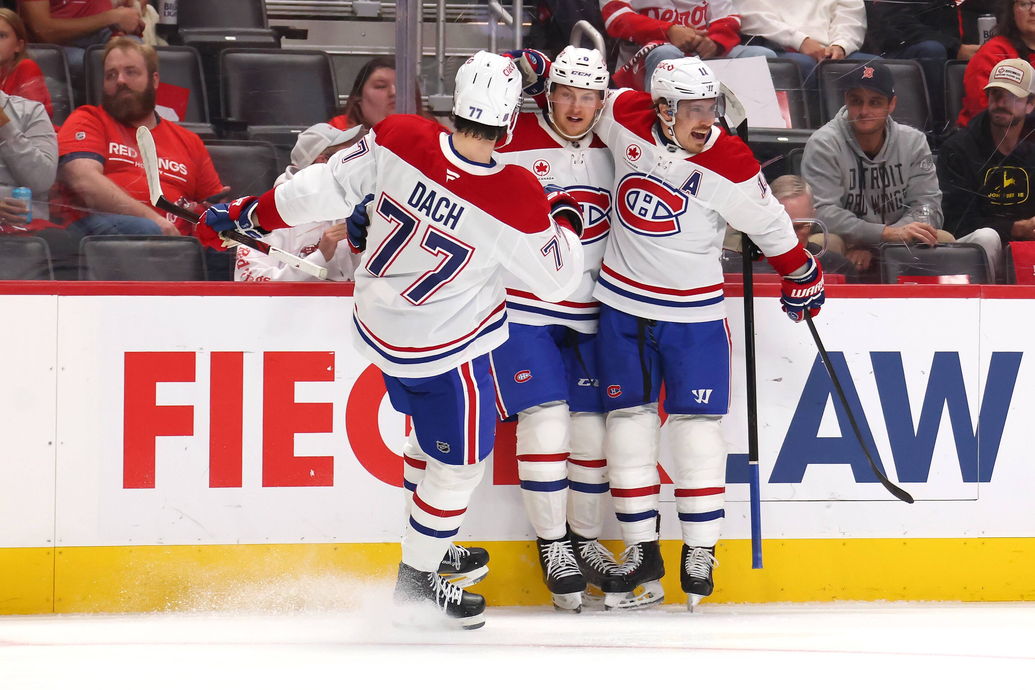 DETROIT, MICHIGAN - OCTOBER 09: Zack Bolduc #76 of the Montreal Canadiens celebrates his first period goal with Kirby Dach #77 and Brendan Gallagher #11 while playing the Detroit Red Wings at Little Caesars Arena on October 09, 2025 in Detroit, Michigan. (Photo by Gregory Shamus/Getty Images)