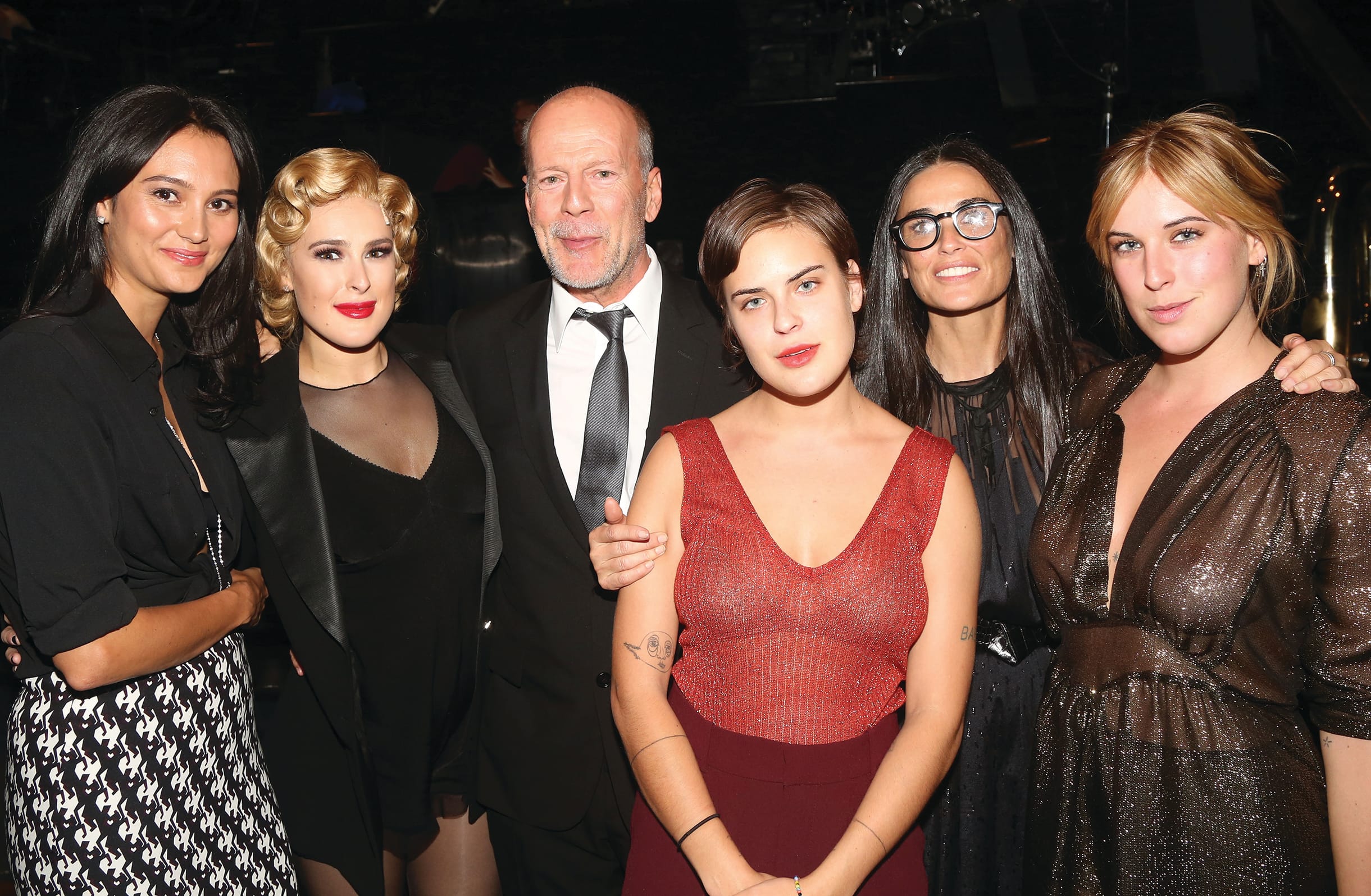 Bruce is surrounded by his wife, Emma Heming, his daughters Rumer, Scout and Tallulah, and their mother, Demi Moore.
