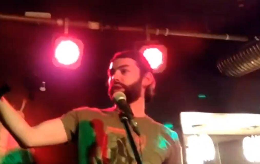 A pro-Putin soldier holding the skull of a Ukrainian soldier on stage