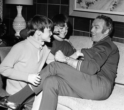 Denis (left) and his brother Gilles tussling with their famous father.