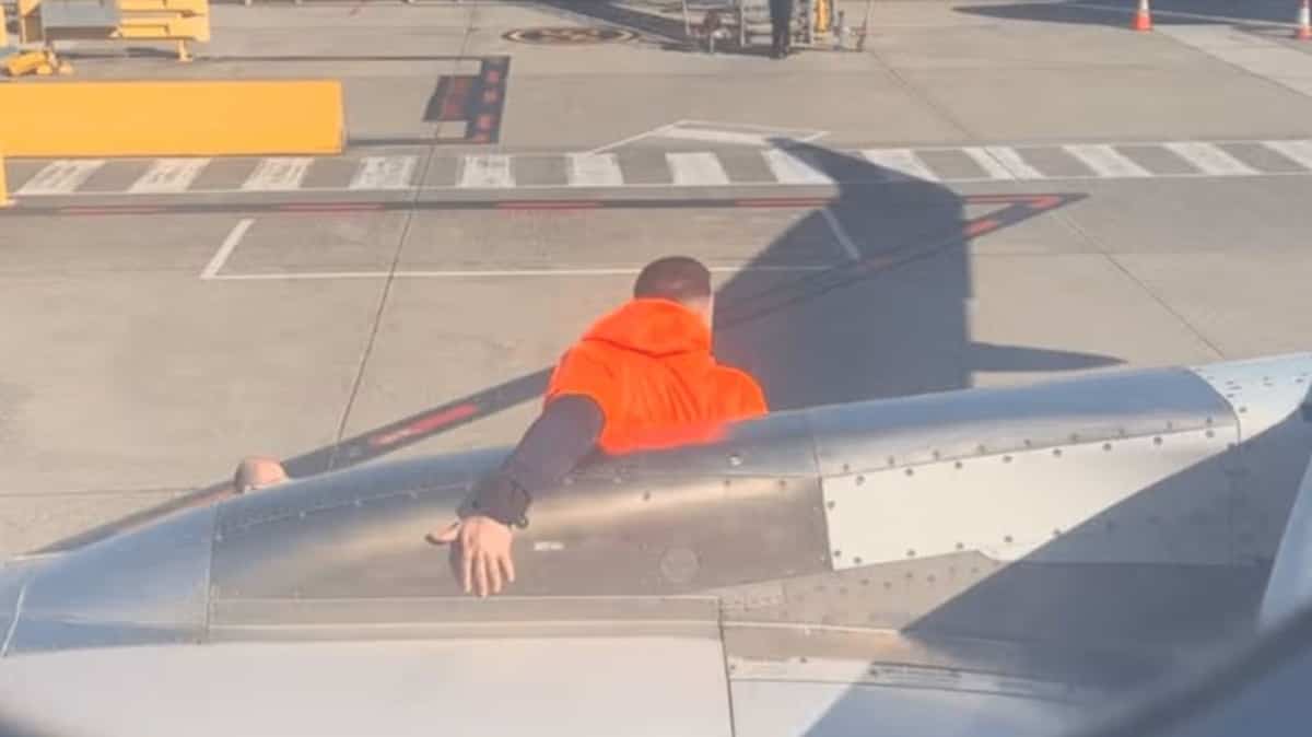 Man opens emergency exit and walks on plane wing Man opens emergency exit and walks on plane wing
