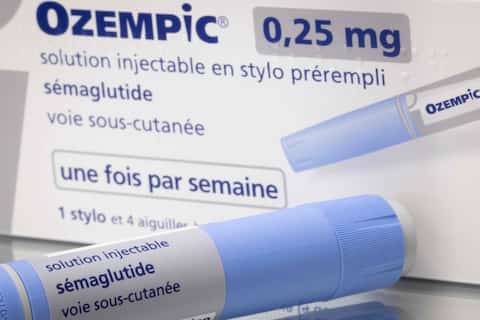 Ozempic Semaglutide Injection Diabetes Drug Being Used For Weight Loss. A Woman Holding an Ozempic Injection Pen in Front of Her Stomach.