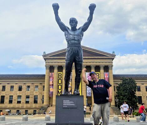 Hugues Fournier in front of the Rocky Balboa statue during a visit to the Philadelphia Art Museum during a sports trip this summer.