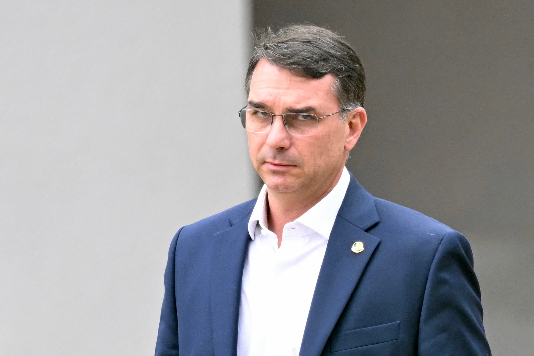Senator Flavio Bolsonaro, son of former Brazilian President Jair Bolsonaro, leaves the Federal Police headquarters where Bolsonaro is detained, in Brasilia, November 25, 2025.
