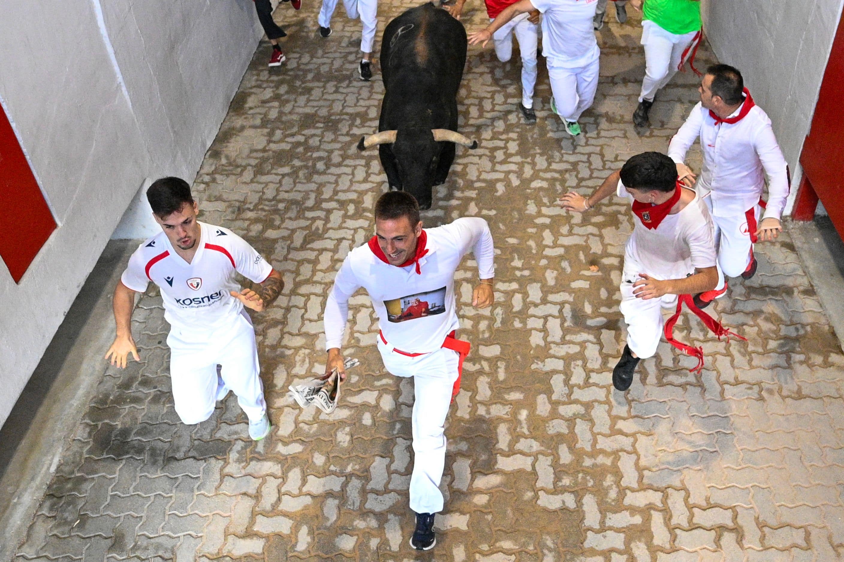 Participants run in front of the bulls of the Jandilla ranch during the eighth bull release of the San Fermin festival in Pamplona, ​​northern Spain, July 14, 2026.