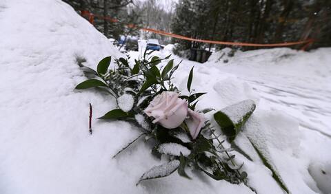 Flowers were laid in the snow in front of the couple's burned residence in the Laurentians.