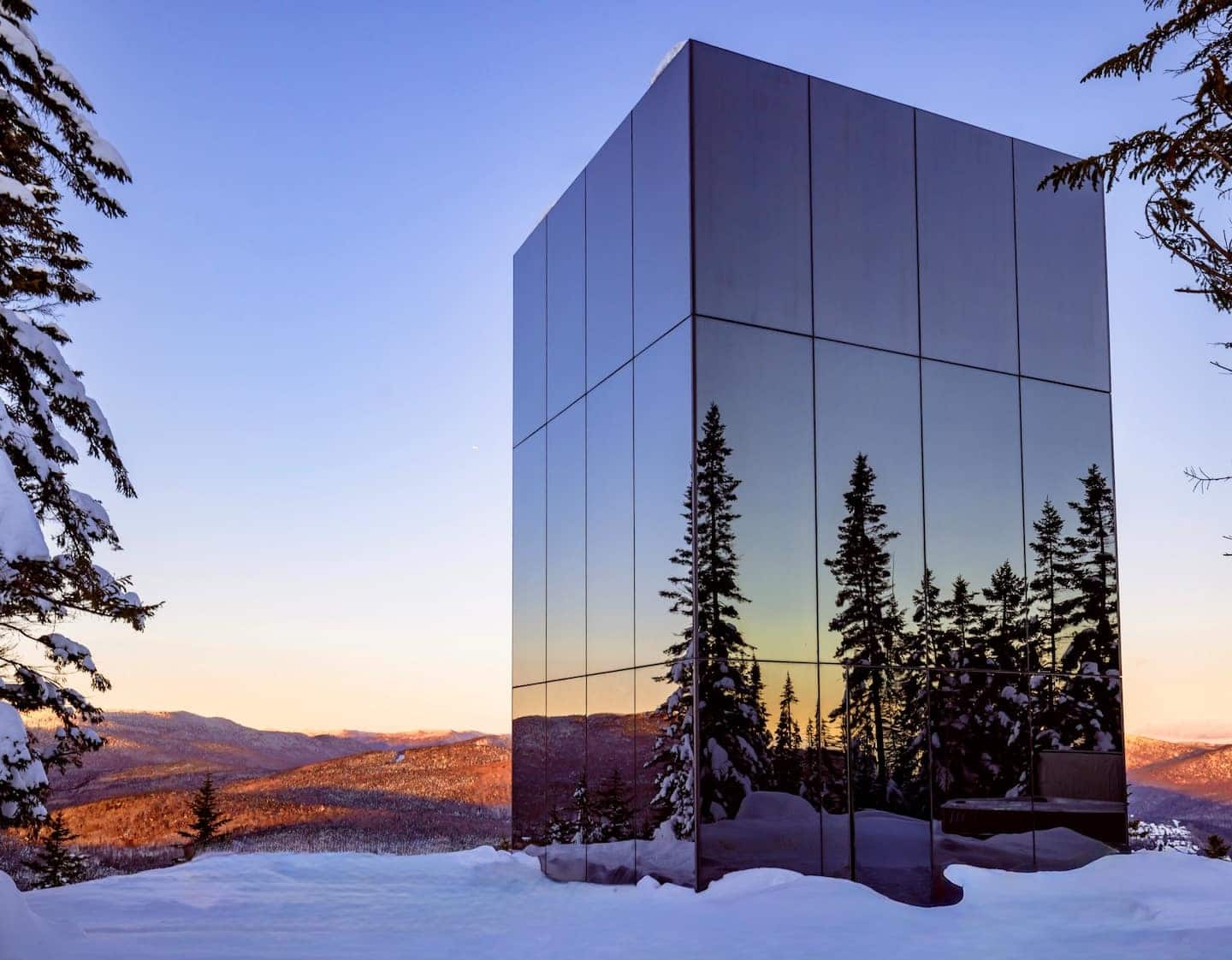 Un chalet de verre au sommet d’une montagne
