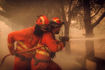 This press photo published on July 26, 2026 and taken on July 24, 2026 by the Spanish Military Emergency Unit (UME) shows members of the UME battling a forest fire near Navas del Rey, 55 kilometers southwest of Madrid.