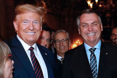 This file photo taken on March 7, 2020 shows U.S. President Donald Trump (L) and former Brazilian President Jair Bolsonaro (R) during a dinner at Mar-a-Lago in Palm Beach, Florida.