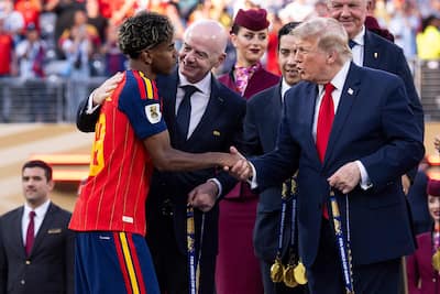 Lamine Yamal (#19) of Spain is congratulated by FIFA President Gianni Infantino and U.S. President Donald Trump during the awards ceremony following the 2026 FIFA World Cup final between Spain and Argentina at New York New Jersey Stadium on July 19, 2026 in East Rutherford, New Jersey.
