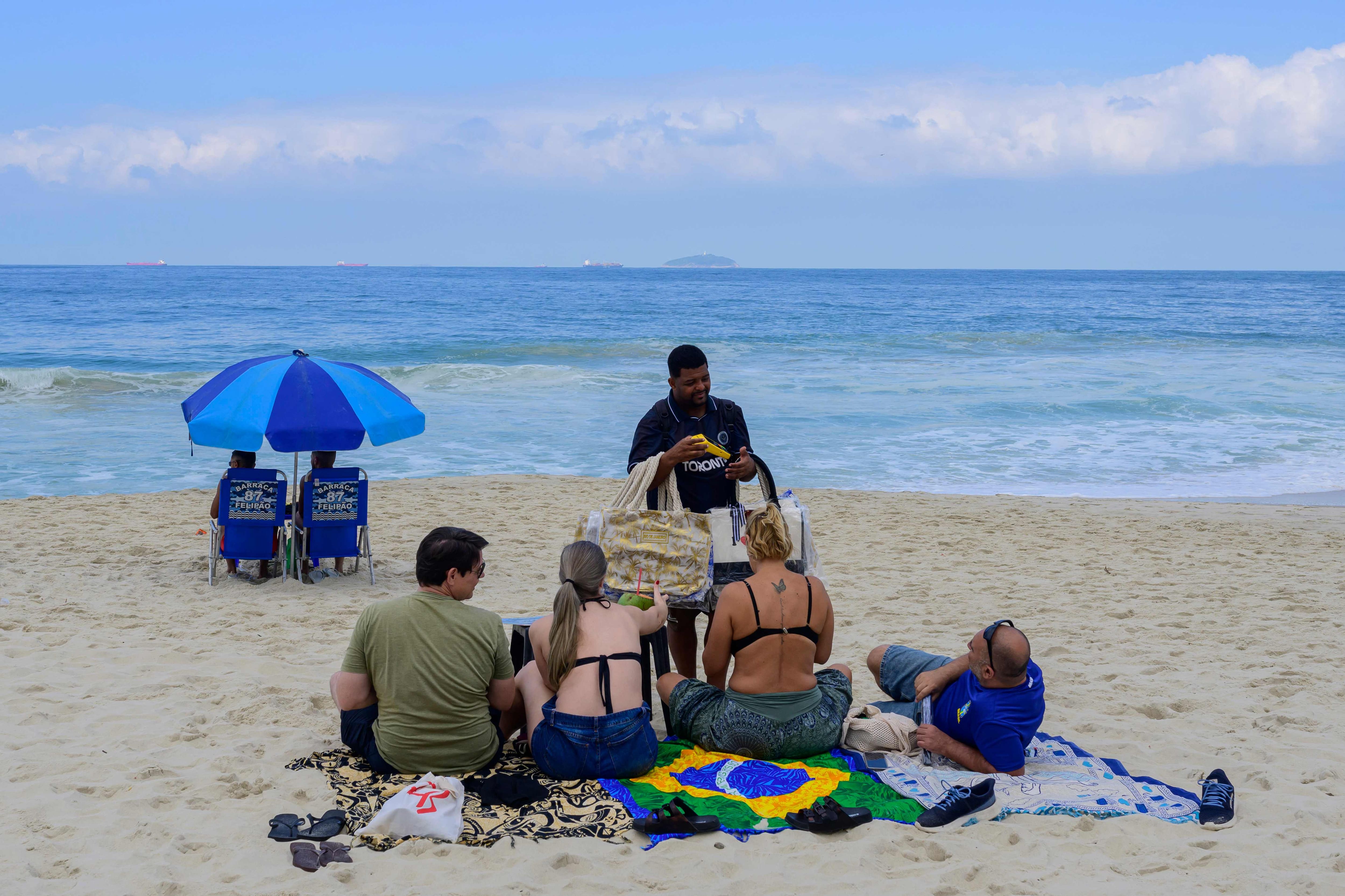A street vendor receives payment through Brazil's Pix instant payment system on Copacabana Beach, Rio de Janeiro, July 9, 2026.