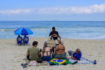 A street vendor receives payment through Brazil's Pix instant payment system on Copacabana Beach, Rio de Janeiro, July 9, 2026.